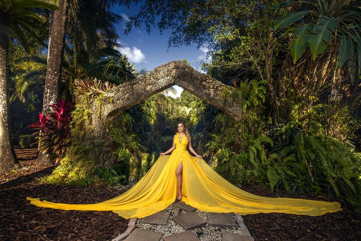 Quincea&ntilde;era photoshoot &mdash; yellow flying dress stone arch at Secret Gardens Miami, Miami Visions Photography