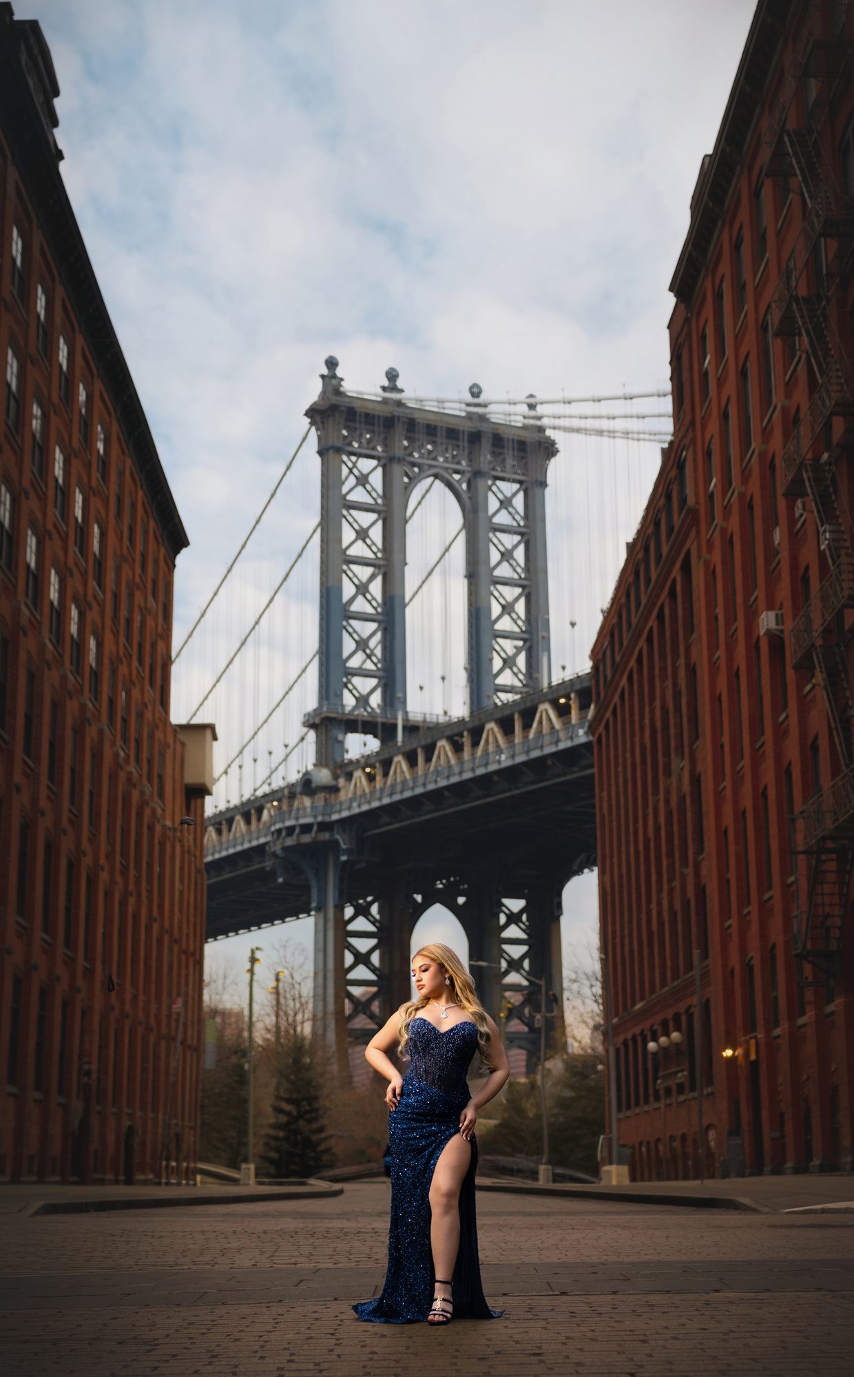 Quinceañera in a navy gown under the Manhattan Bridge, DUMBO