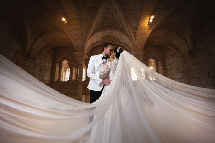 Bride groom kiss flowing veil stone hall &mdash; wedding photography by Miami Visions, Miami