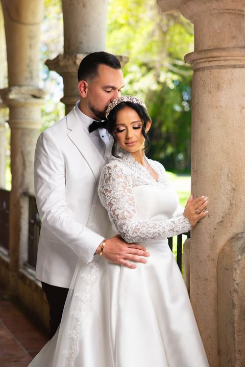 Groom kiss bride forehead columns &mdash; wedding photography by Miami Visions, Miami