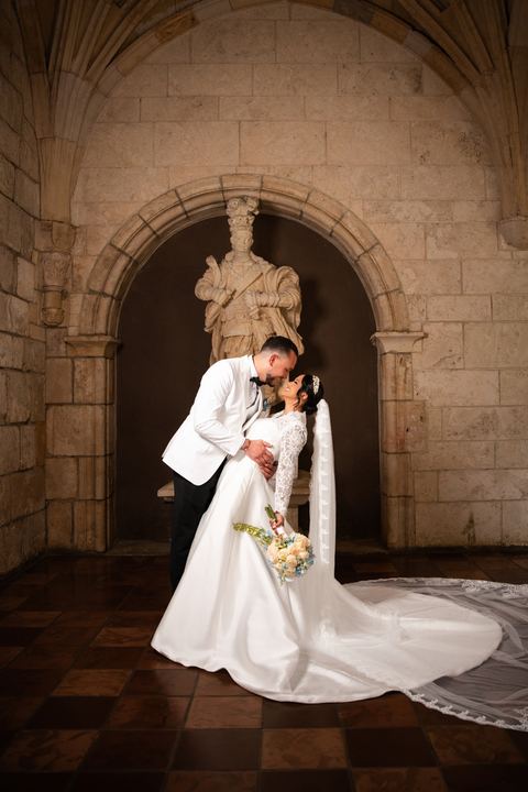 Groom dip kiss stone arch &mdash; wedding photography by Miami Visions, Miami