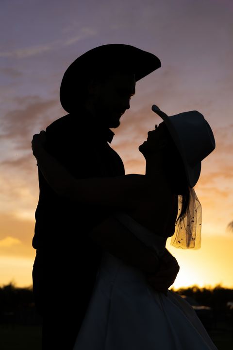 Bride groom hat silhouette embrace &mdash; wedding photography by Miami Visions, Miami