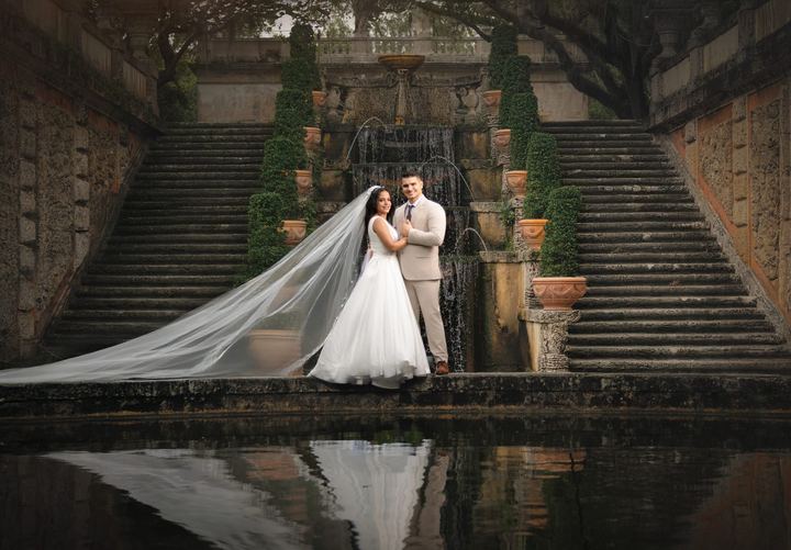 Bride and groom at Vizcaya fountain, luxury Miami wedding photographer