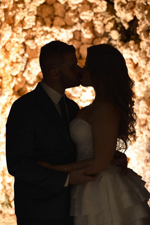 Bride and groom silhouette kiss, dramatic wedding portrait Miami